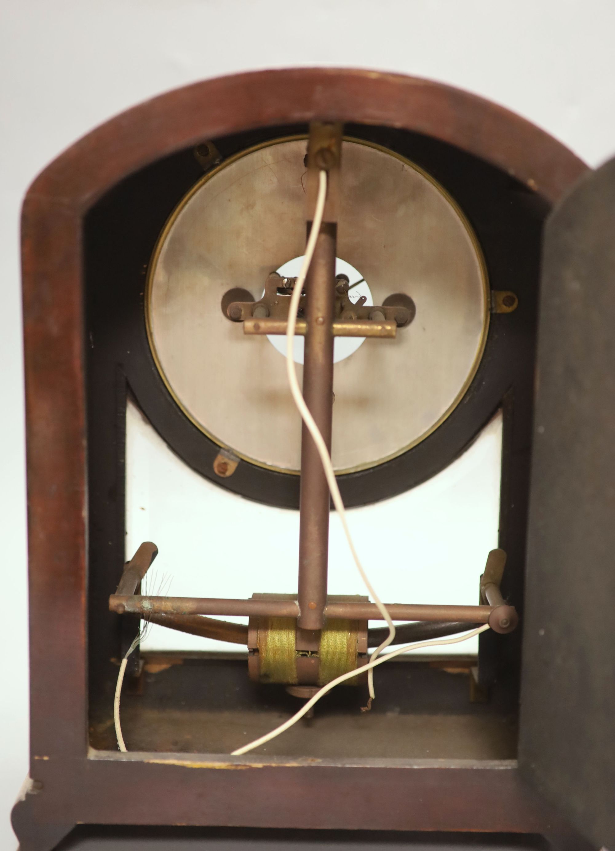 A Bulle mahogany mantel clock, with laurel wreath carving to the arched top, height 32cm